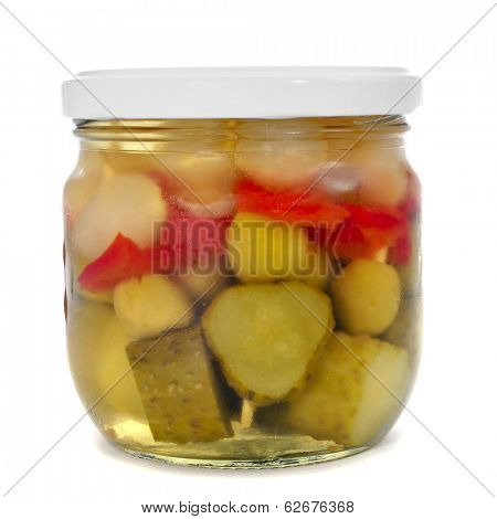 a jar with spanish banderillas, skewers with different pickles, such as olives, garlic, cucumbers, onion and red pepper