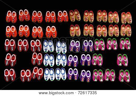 Small Dutch wooden shoes against a black background