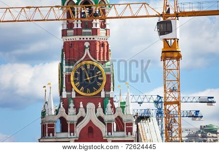 Kremlin clock up view with construction cranes