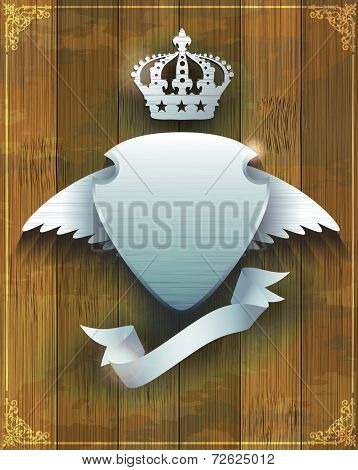 steel badge with wings and crown