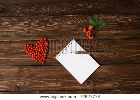 Ashberry as a heart shape and pencil at the table