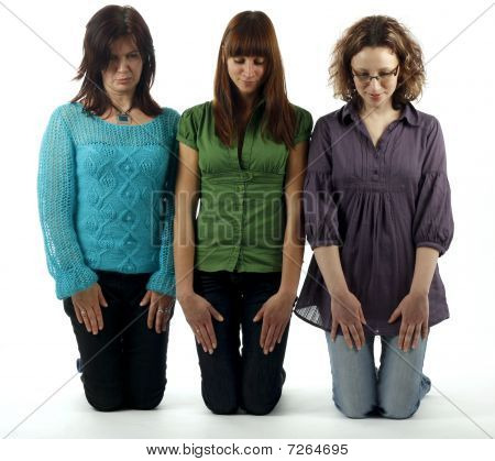 Three shy girls kneeing on floor