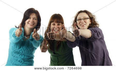 Portrait of three young women laughing and giving the thumbs-up sign