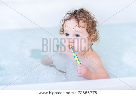 Adorable Baby Girl With Big Blue Eyes Brushing Her Teeth Taking A Bath With Foam