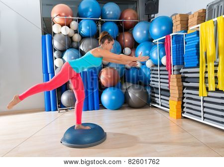 bosu one leg extension deadlift girl exercise at gym workout and swiss ball background