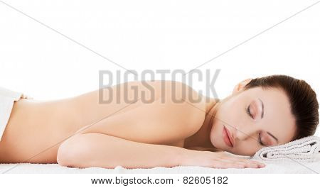 Woman lying on a towel ready to massage.