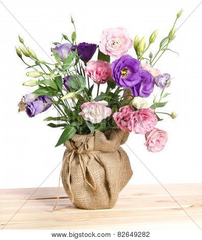 Beautiful Bouquet Of  Eustome Flowers In Flowerpot  On The Wooden Table