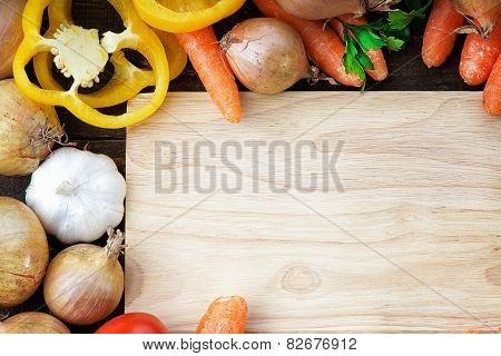 Fresh vegetables mix and wooden cutting board