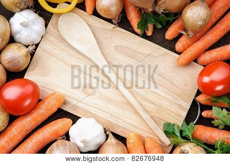 Healthy,fresh vegetables with wooden spoon and board