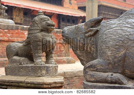 PATAN, NEPAL - APRIL 2014 : A statue of cow and snow lion at Patan Darbar Square on 13 April 2014 in Patan, Nepal