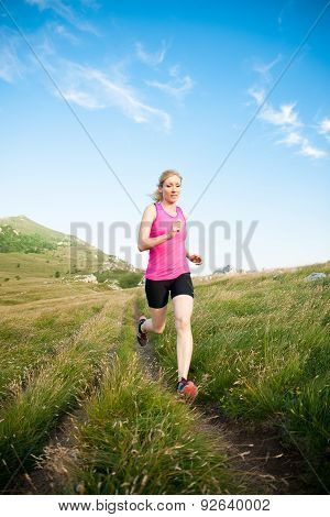 Beautiful Young Woman Runns Cross Country On A Mountian Path At Sunrise