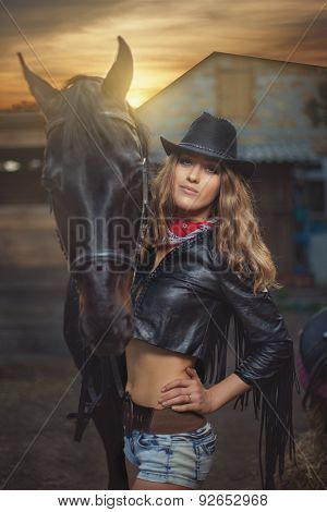 Girl Cowboy Standing Near A Horse.