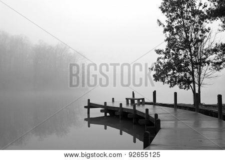 Thick Blanket Of Fog Covers Lake And Wooden Dock