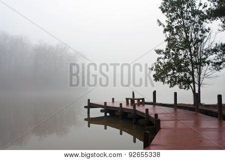 Thick Blanket Of Fog Covers Lake And Wooden Dock