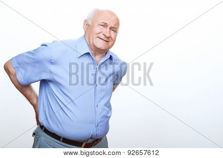 Exhausted grandfather touching his back