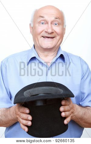 Smiling grandfather standing with hat