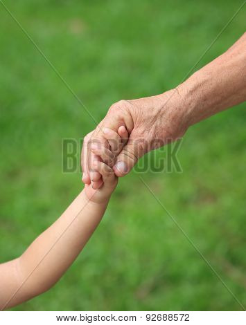 Child and grandma holding hands