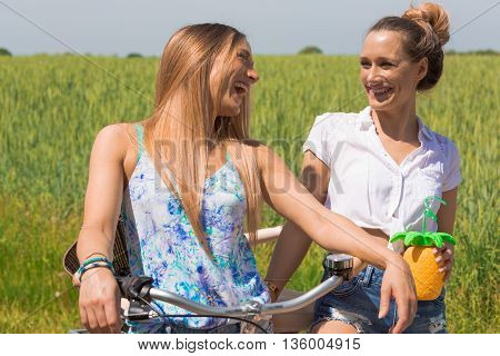 trendy twin girls making a bike tour. summerfeeling.
