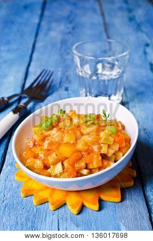 Vegetable stew with sauce on wooden background. Selective focus.