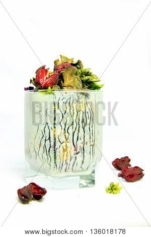 dried flowers in a glass of Kefir yogurt stains white background abstraction still life.