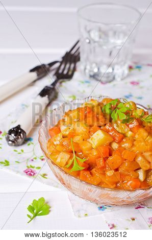 Vegetable stew with sauce on wooden background. Selective focus.
