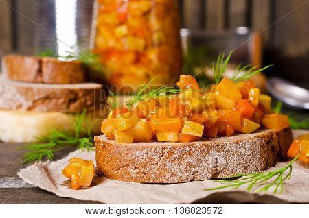 Open sandwich with steamed vegetables on a wooden background. Selective focus.
