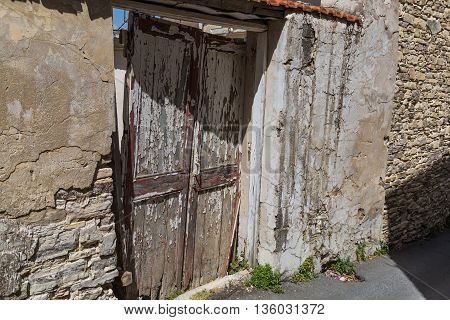 old broken wooden door in abandoned stone house. Lefkara. Cyprus