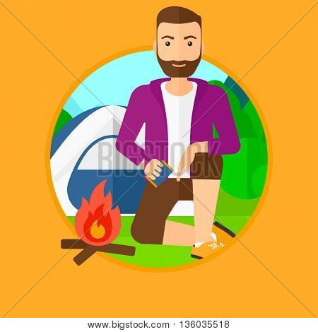 A hipster man with the beard kindling a campfire on the background of camping site with tent. Tourist relaxing near campfire. Vector flat design illustration in the circle isolated on background.