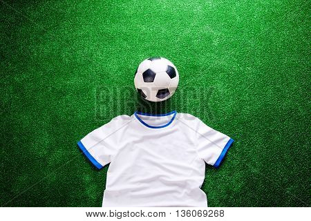 Soccer Ball And White T-shirt Against Artificial Turf