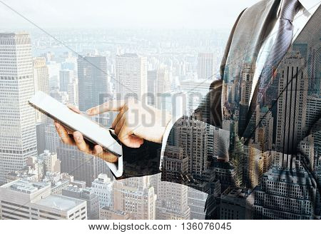 Businessman using smartphone on New York city background. Mock up Double exposure
