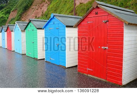 Row of colourful beach huts in Seaton, Devon