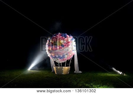 Fake ball standing on field, made of paper flowers