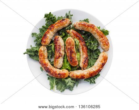 Links of the cooked homemade sausages on the plate with cale