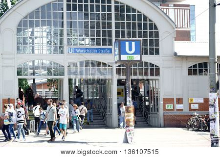 BERLIN, GERMANY - MAY 09: The busy entrance to the Metro Station Warsaw Street in Berlin Friedrichshain with pedestrians and passersby on May 09, 2015 in Berlin.