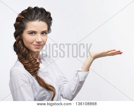 Beautiful woman with braids smiling over white background. Felame in white blouse with modern hairstyle in studio. Hairdressing concept.