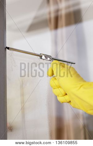 Cleaning windows using window squeegee