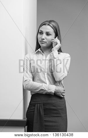 Businesswoman Talking On Telephone In Office