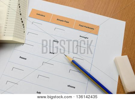 english exercise and pencil and book. on table represent doing english exercise