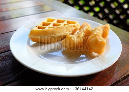 waffle and deep-fried dough on the plate in the table