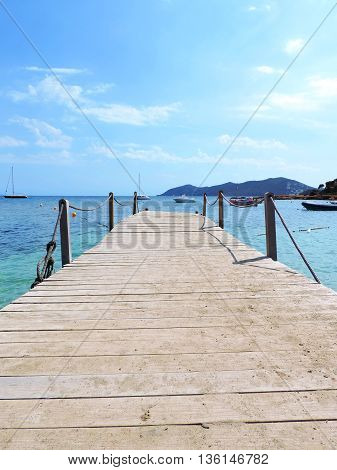 Wooden Gangplank or boardwalk into the sea. Pier or jetty.