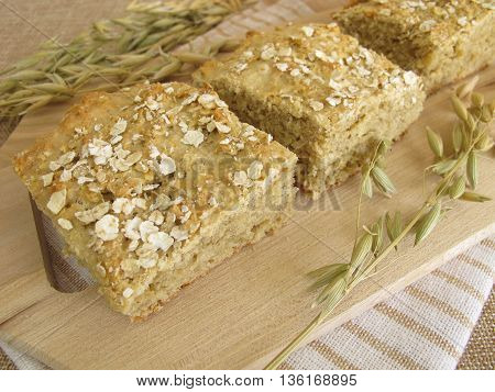 Homemade oatcake and oats on wooden board