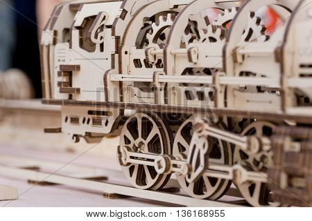 Selective focus on Children's wooden steam locomotive assembled from cut parts