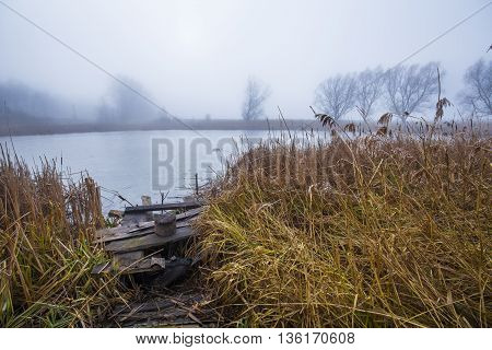autumn morning at a forest lake with fog and beautiful warm colors