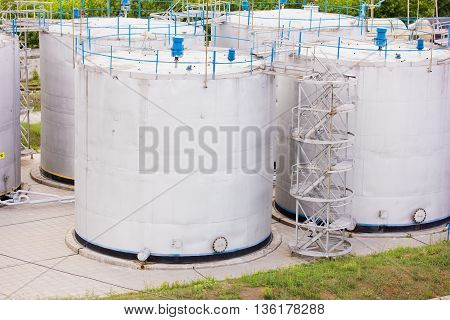 large white tanks for petrol and oil
