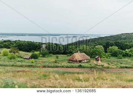 Old wooden house in mountain and river - Ukraine.