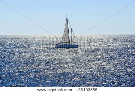 Sailing ship yachts with white sails in the open sea