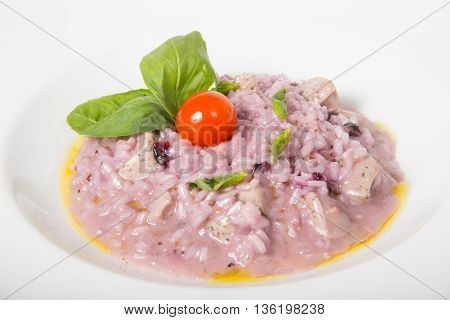 Purple itlian rice dish with cherry tomato and basil