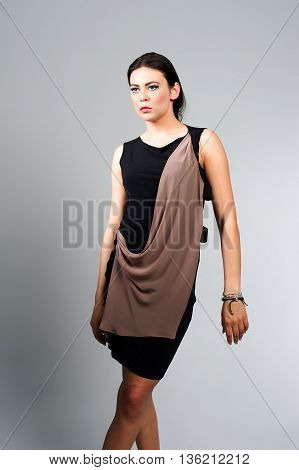 fashion model posing in studio, she wear evening dress
