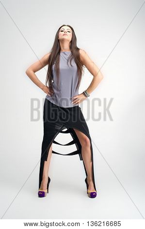 beautiful young girl posing to camera in fashion dress