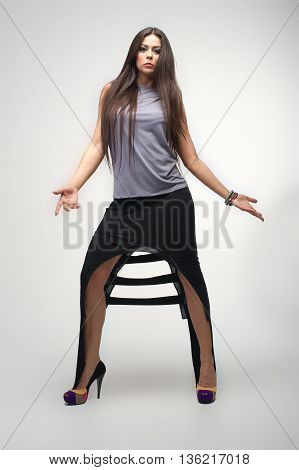 beautiful young girl posing to camera in fashion dress